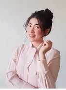 Head shot of Dr Yao Wang, smiling, with dark hair worn up, wearing a pale pink blouse, against a light background.