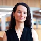 Headshot of Dr Caroline Claisse, in a black sleeveless vneck top with long hair worn down